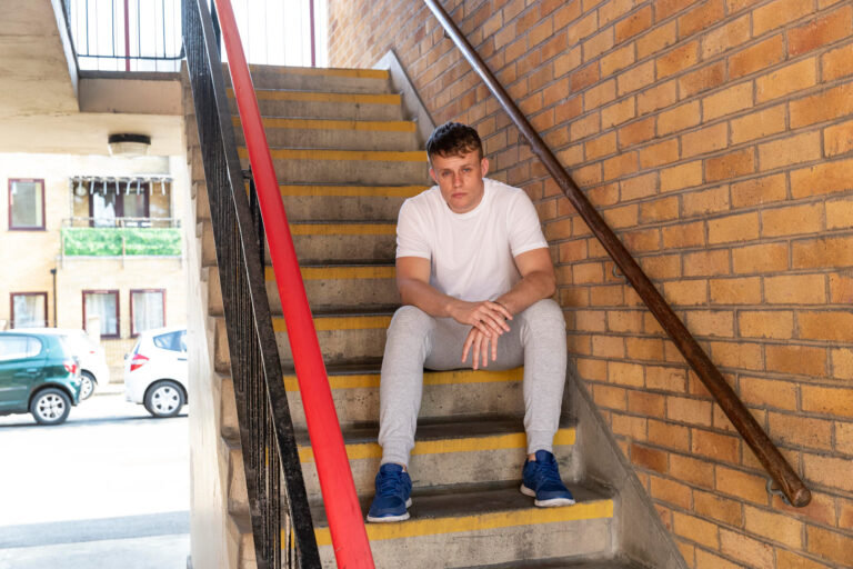 full-shot-man-sitting-on-stairs 2